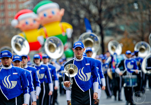 Georgia State University trombone player Isaac Dolan (center) marches down Peachtree St. during the 2014 Children's Christmas Parade in Atlanta on Saturday, December 6, 2014. 