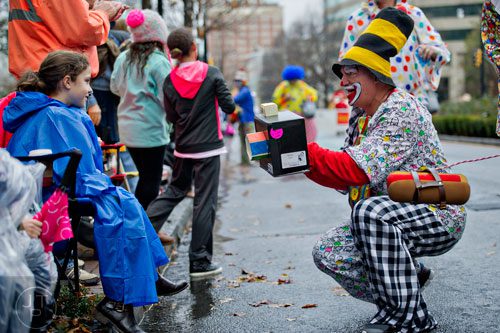Danny Shaw (right) takes a photo of Mariah Cuneo during the 2014 Children's Christmas Parade in Atlanta on Saturday, December 6, 2014. 