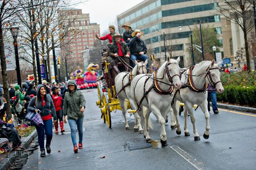 Horses pull the Wells Fargo stage coach down Peachtree St. during the 2014 Children's Christmas Parade in Atlanta on Saturday, December 6, 2014. 