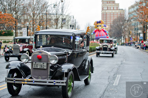 Model A cars drive down Peachtree St. during the 2014 Children's Christmas Parade in Atlanta on Saturday, December 6, 2014. 