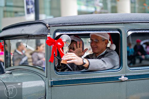 John Maloney drives his 1929 Model A down Peachtree St. during the 2014 Children's Christmas Parade in Atlanta on Saturday, December 6, 2014. 