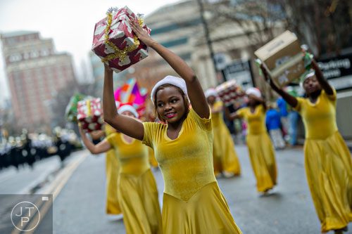 Ralyn McConico (center) dances down Peachtree St. during the 2014 Children's Christmas Parade in Atlanta on Saturday, December 6, 2014.