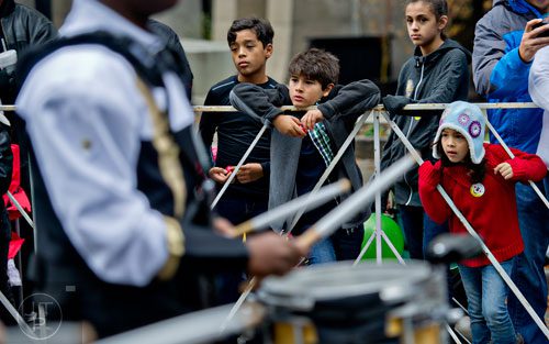 Isabella Castillo (right), her brother Eduardo (left) and Lauren and Christopher Beeco watch a band pass by during the 2014 Children's Christmas Parade in Atlanta on Saturday, December 6, 2014. 