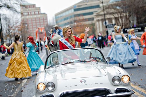 Miss Georgia, Maggie Bridges (center), waves to the crowd during the 2014 Children's Christmas Parade in Atlanta on Saturday, December 6, 2014. 
