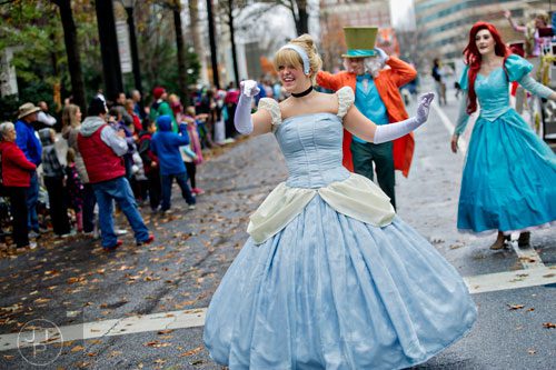 Dressed as Cinderella, Amanda Gibson waves to the crowd during the 2014 Children's Christmas Parade in Atlanta on Saturday, December 6, 2014. 