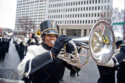 Nnenna Ounourah (center) plays her baritone with the Mountain View High School band as they march down Peachtree St. during the 2014 Children's Christmas Parade in Atlanta on Saturday, December 6, 2014.