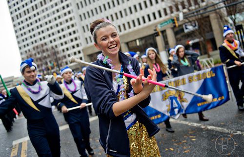 Ally Bradley (center) twirls her baton with the Appalachee High School band as they march down Peachtree St. during the 2014 Children's Christmas Parade in Atlanta on Saturday, December 6, 2014.