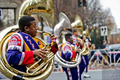 Deandre Hunter (left) plays his tuba with the Fairfield High School band as they march down Peachtree St. during the 2014 Children's Christmas Parade in Atlanta on Saturday, December 6, 2014. 