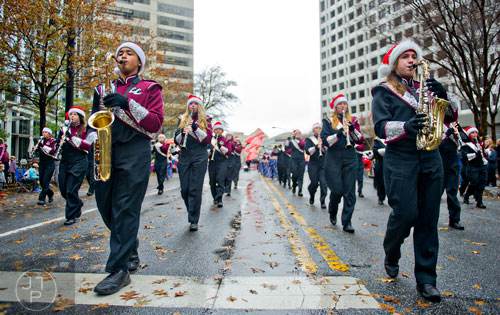 Chris Howell (left) and Natalie Bowen (right) play their saxophones with the Central High School band as they march down Peachtree St. during the 2014 Children's Christmas Parade in Atlanta on Saturday, December 6, 2014. 
