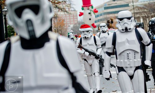 Dressed as a storm trooper, Brent Borron (center) marches down Peachtree St. with the 501st Legion during the 2014 Children's Christmas Parade in Atlanta on Saturday, December 6, 2014. 