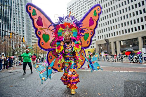 Joycelyn Daley (center) dances down Peachtree St. during the 2014 Children's Christmas Parade in Atlanta on Saturday, December 6, 2014. 