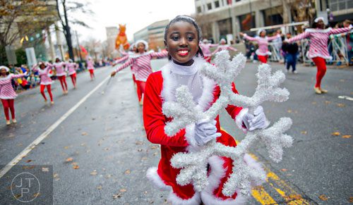 Melvea Safo (center) dances down Peachtree St. during the 2014 Children's Christmas Parade in Atlanta on Saturday, December 6, 2014. 