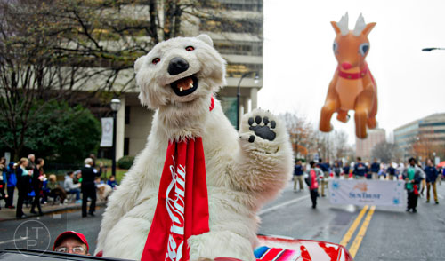 The Coca-Cola polar bear waves to the crowd during the 2014 Children's Christmas Parade in Atlanta on Saturday, December 6, 2014. 