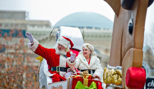 Santa and Mrs. Claus wave from their sleigh as they particiapte in the 2014 Children's Christmas Parade in Atlanta on Saturday, December 6, 2014. T