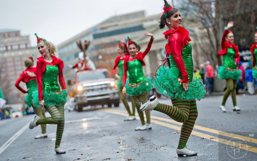 Jess Charmoli (right) tap dances down Peachtree St. during the 2014 Children's Christmas Parade in Atlanta on Saturday, December 6, 2014.