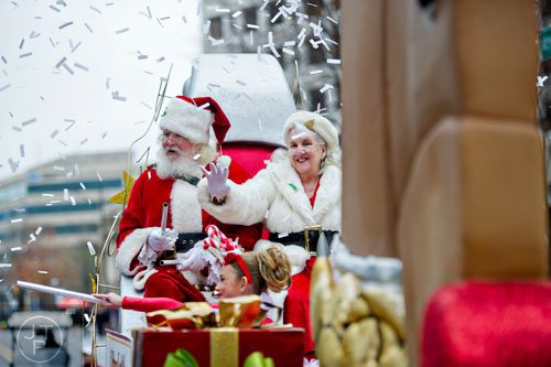 Santa and Mrs. Claus wave from their sleigh as they particiapte in the 2014 Children's Christmas Parade in Atlanta on Saturday, December 6, 2014. 