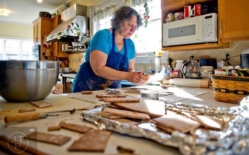 Emily Wert kneads gingerbread in her hands as she works on a replica of Laketown from "The Hobbit" movies at her home in Atlanta on Friday, December 12, 2014. 