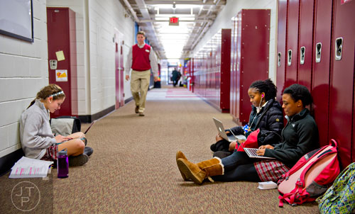  Ileana Zeissner (left), Briana Neal and Saaleha Medlock sit in a hallway as they study for final exams at Holy Innocents' Episcopal School in Atlanta on Friday, December 19, 2014.