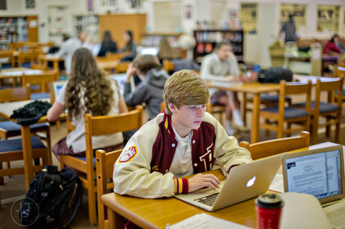 Chris Cotton (center) studies for final exams at Holy Innocents' Episcopal School in Atlanta on Friday, December 19, 2014. 