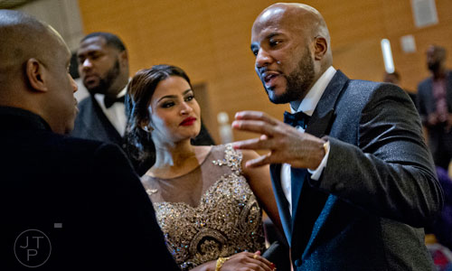 Young Jeezy (right) talks with guests during the 31st annual United Negro College Fund Mayor's Masked Ball at the Atlanta Marriott Marquis in downtown on Saturday, December 20, 2014.