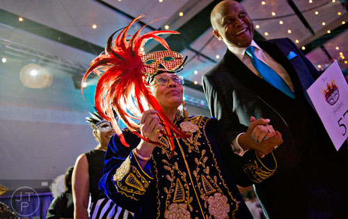 Dr. Doris Derby (left) and Don Rivers walk in the Parade of Masks during the 31st annual United Negro College Fund Mayor's Masked Ball at the Atlanta Marriott Marquis in downtown on Saturday, December 20, 2014. 