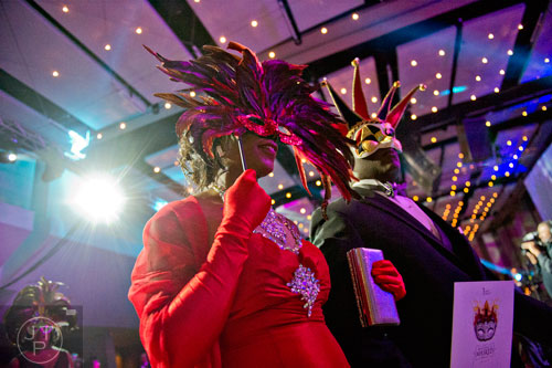 Dr. Barbara Brown (left) and her husband Darrell walk in the Parade of Masks during the 31st annual United Negro College Fund Mayor's Masked Ball at the Atlanta Marriott Marquis in downtown on Saturday, December 20, 2014. 
