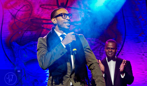 Ludacris (left) stands on stage with Atlanta mayor Kasin Reed during the 31st annual United Negro College Fund Mayor's Masked Ball at the Atlanta Marriott Marquis in downtown on Saturday, December 20, 2014. 