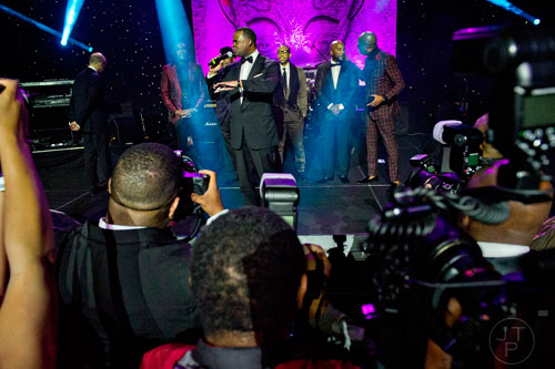 Atlanta mayor Kasin Reed (center) stands on stage with Chris Tucker (left), Ludacris, Young Jeezy and Jonathan Slocumb during the 31st annual United Negro College Fund Mayor's Masked Ball at the Atlanta Marriott Marquis in downtown on Saturday, December 20, 2014. 