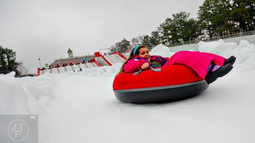 Jalen Guy zooms down the hill in her tube during Snow Mountain at Stone Mountain Park on Sunday, December 21, 2014. 