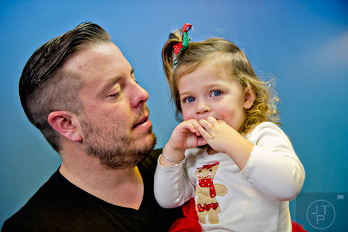Pastor Josiah Potter (left) talks to his daughter Sunday, 2, after worship service at Crosspointe Church in Peachtree City on Sunday, December 21, 2014. 