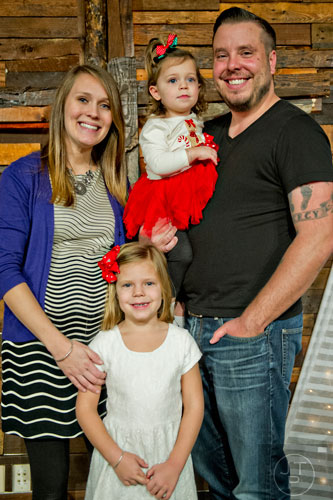 Pastor Josiah Potter (right) stands with his wife Jordan and their daughtersMercy, 4, and Sunday, 2, after worship service at Crosspointe Church in Peachtree City on Sunday, December 21, 2014.