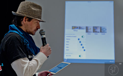 Michael Brodeur pitches an app he helped create with his team to a panel of judges during The Weather Channel's Hack-A-Thon at the Atlanta Marriott Northwest at Galleria on Friday, December 12, 2014. 