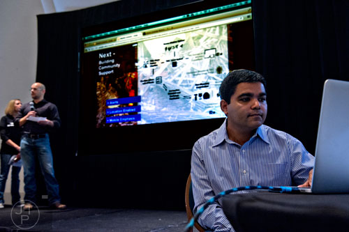 Vishal Shrivastava (right) demonstrates an app with his team to a panel of judges during The Weather Channel's Hack-A-Thon at the Atlanta Marriott Northwest at Galleria on Friday, December 12, 2014. 