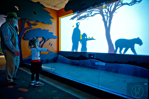 Dr. Dean Tucker (left) and his granddaughter Lydia Morley check out an interactive display in the Goosebumps: The Science of Fear exhibit at the Fernbank Museum of Natural History in Atlanta on Saturday, December 27, 2014.  