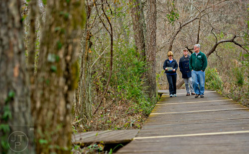 Philomena Strenger (left), her son Anton and husband Carl hike along the River Boardwalk Trail at the Chattahoochee Nature Center in Roswell on Saturday, December 27, 2014. 