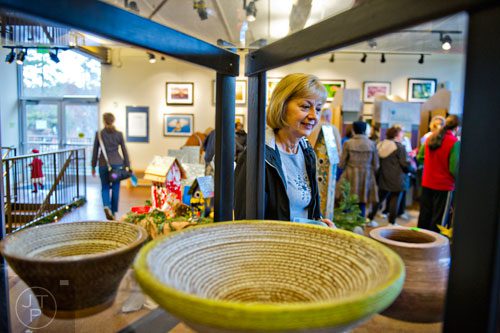 Sharon Butler looks at bowls made from cardboard during the Back-to-Nature Holiday Market and Festival at the Chattahoochee Nature Center in Roswell on Saturday, December 6, 2014. 
