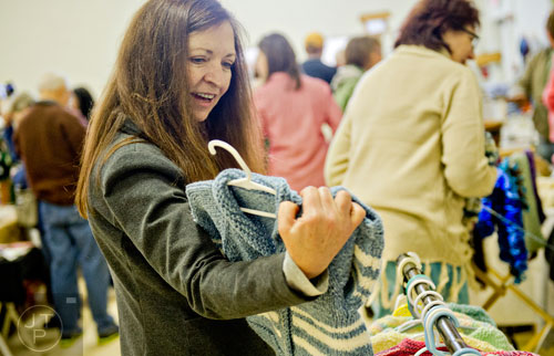 Terry Smyth looks at a sweater during the Back-to-Nature Holiday Market and Festival at the Chattahoochee Nature Center in Roswell on Saturday, December 6, 2014. 