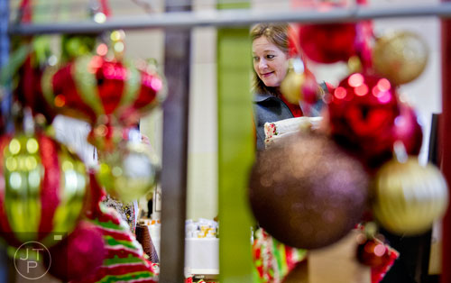 Robin Heim looks at different holiday art during the Back-to-Nature Holiday Market and Festival at the Chattahoochee Nature Center in Roswell on Saturday, December 6, 2014. 