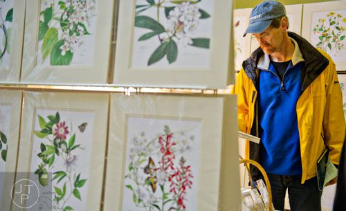 Ken Boff looks at paintings of southeastern plants and flowers during the Back-to-Nature Holiday Market and Festival at the Chattahoochee Nature Center in Roswell on Saturday, December 6, 2014. 