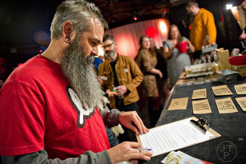 Corey Beaman registers for the 4th annual Battle of the Beards at Smith's Olde Bar in Atlanta on Saturday, December 13, 2014. 