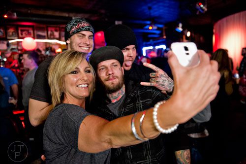 Cindy Terry (left), Jordan Brooks, C.J. Bass and Justin Haus take a selfie as they wait for the start of the 4th annual Battle of the Beards at Smith's Olde Bar in Atlanta on Saturday, December 13, 2014. 