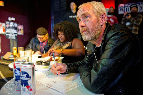 Judges Bill Danforth (right), Dulce Sloan and Eric Von Haessler take notes during the 4th annual Battle of the Beards at Smith's Olde Bar in Atlanta on Saturday, December 13, 2014.
