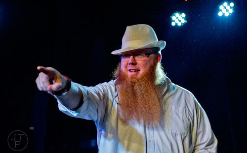 Seth Nixon plays to the crowd as he competes in the Best Partial competition during the 4th annual Battle of the Beards at Smith's Olde Bar in Atlanta on Saturday, December 13, 2014. 