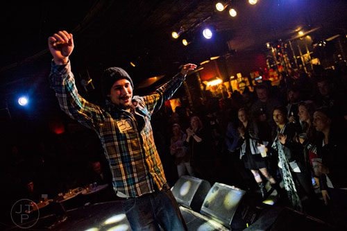 Blake Baker (left) plays to the crowd as he competes in the Best Partial competition during the 4th annual Battle of the Beards at Smith's Olde Bar in Atlanta on Saturday, December 13, 2014. 