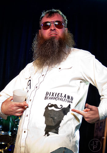 Jeffrey Mach plays to the crowd as he competes in the Best Partial competition during the 4th annual Battle of the Beards at Smith's Olde Bar in Atlanta on Saturday, December 13, 2014. 