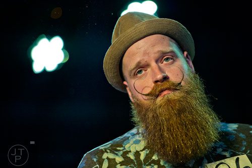 Daniel Keith plays up to the crowd in the Best Stache competition during the 4th annual Battle of the Beards at Smith's Olde Bar in Atlanta on Saturday, December 13, 2014. 