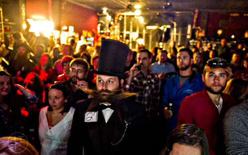 Josh Seehorn (center) waits for his turn to compete on stage during the 4th annual Battle of the Beards at Smith's Olde Bar in Atlanta on Saturday, December 13, 2014. 