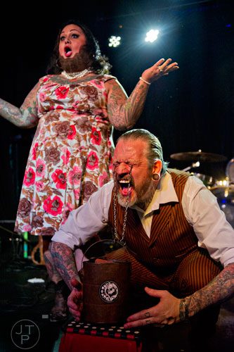 Captain Stab-Tuggp (right) lifts a bucket attached to his eye lids as he performs on stage with his partner Maybelle during the 4th annual Battle of the Beards at Smith's Olde Bar in Atlanta on Saturday, December 13, 2014.