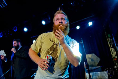 J.D. Dean (center) plays up to the crowd in the Best Grooming competition as Mike Albanese emcees during the 4th annual Battle of the Beards at Smith's Olde Bar in Atlanta on Saturday, December 13, 2014. 