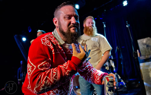 Brian Whitcomb (center) plays to the crowd as he competes in the Best Grooming competition during the 4th annual Battle of the Beards at Smith's Olde Bar in Atlanta on Saturday, December 13, 2014. 